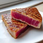 Two thick slices of seared tuna steak, perfectly rare inside, coated with spices from the MARINADE FOR TUNA STEAK.